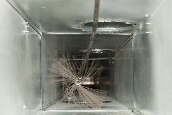 Residential HVAC duct cleaning with a power brush.