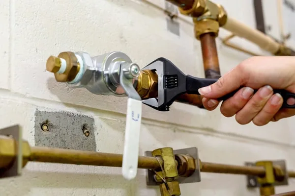 plumber performs gas pipe repair service