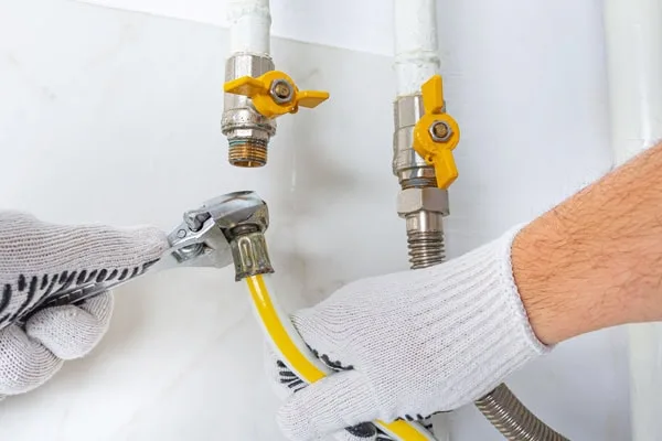 Plumber performing gas pipe replacement