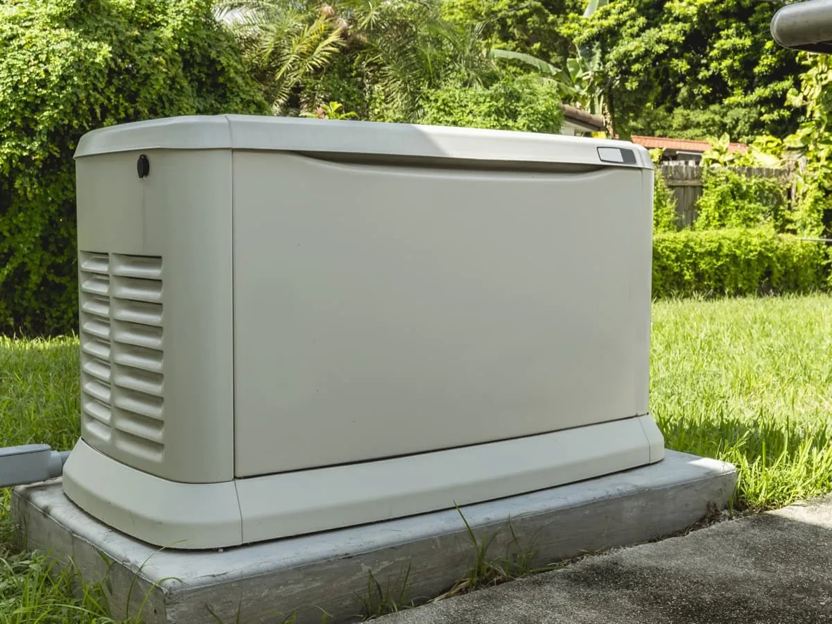 Standby home generator installed beside a house
