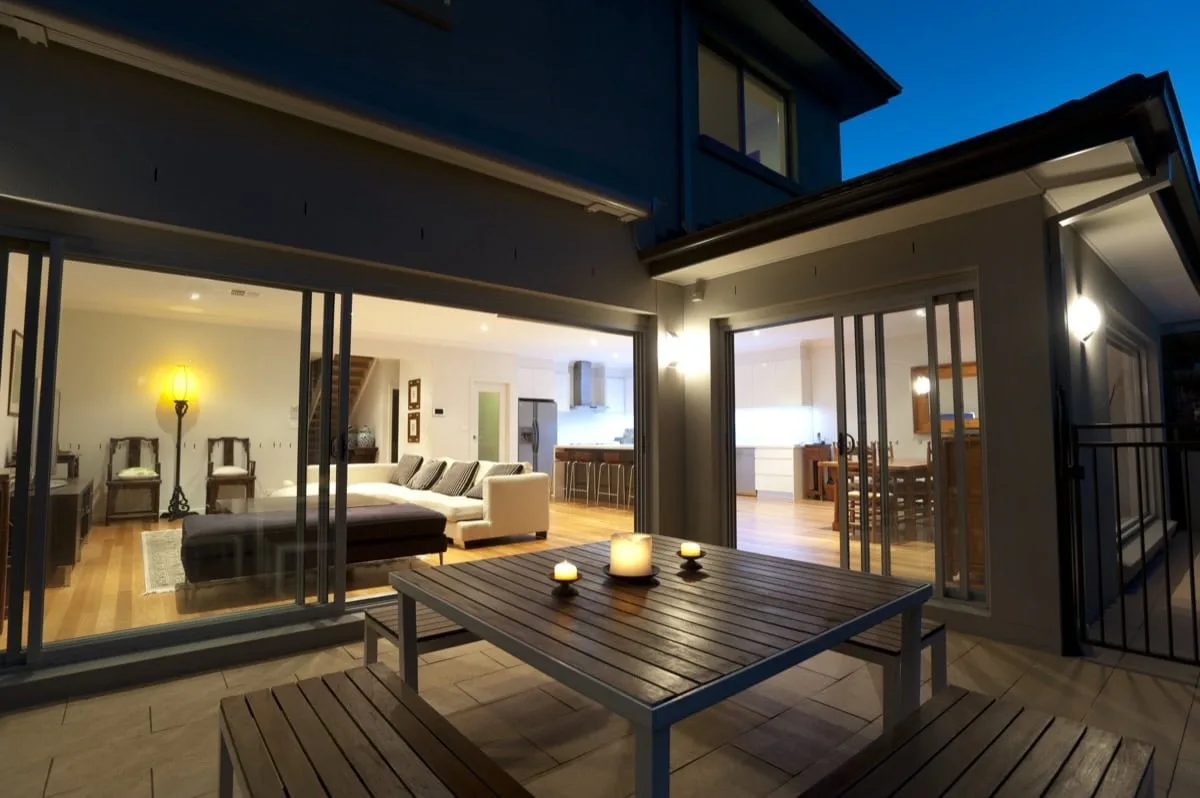 Indoor outdoor living room lighting in the evening.