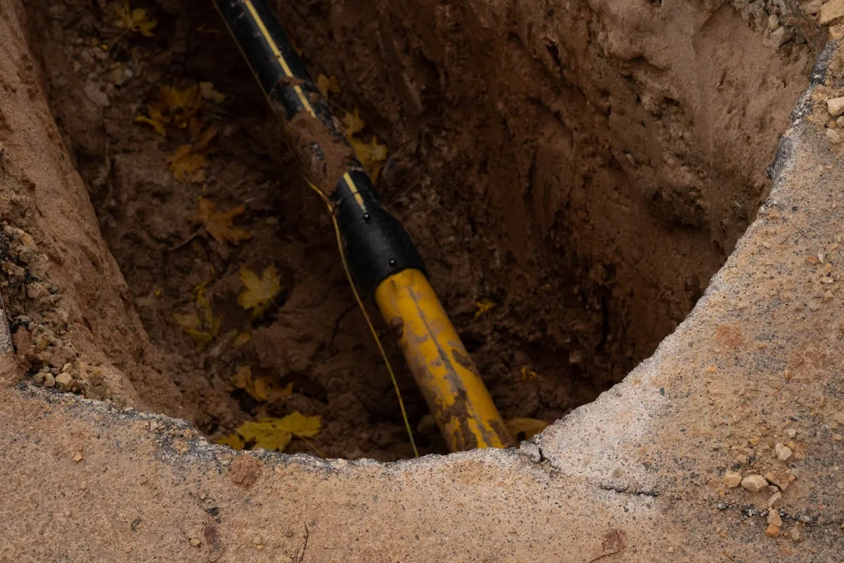Trenchless pipe bursting equipment at a dig site