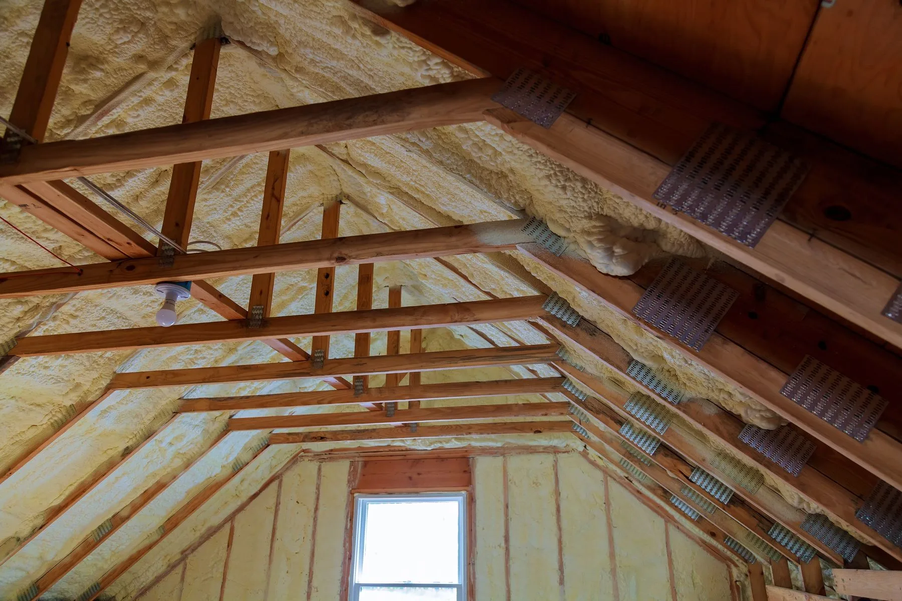 Attic interior with newly installed insulation between the rafters