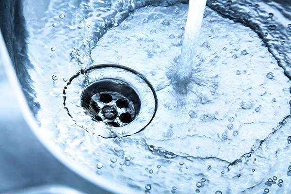 Kitchen sink with running water.