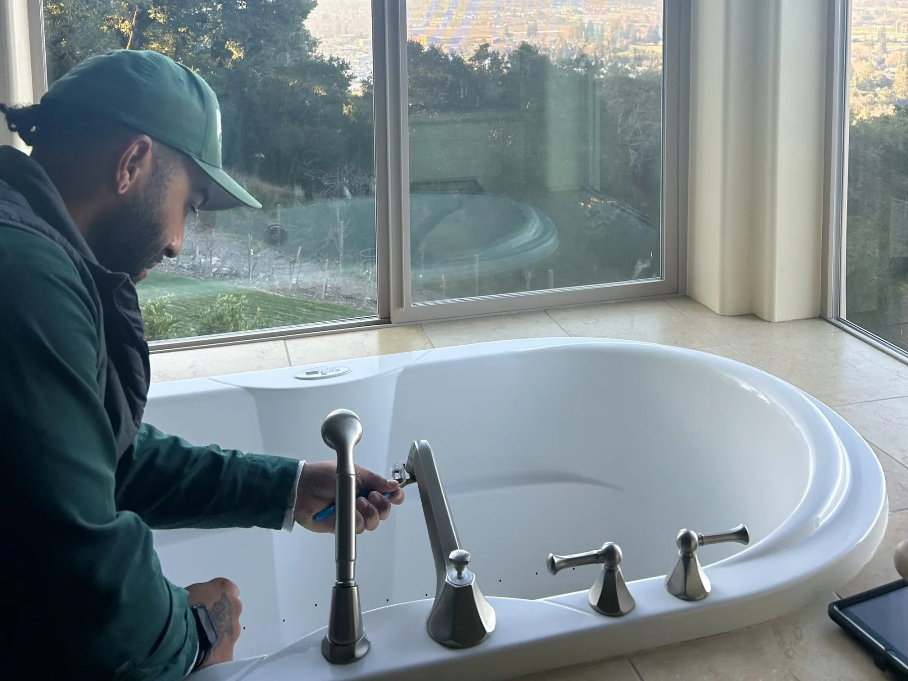 Ongaro & Sons technician servicing a Roman tub faucet at a hillside North Bay home
