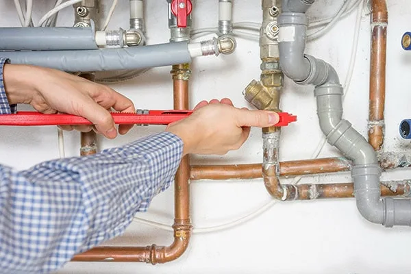 Plumber fixing central heating system.