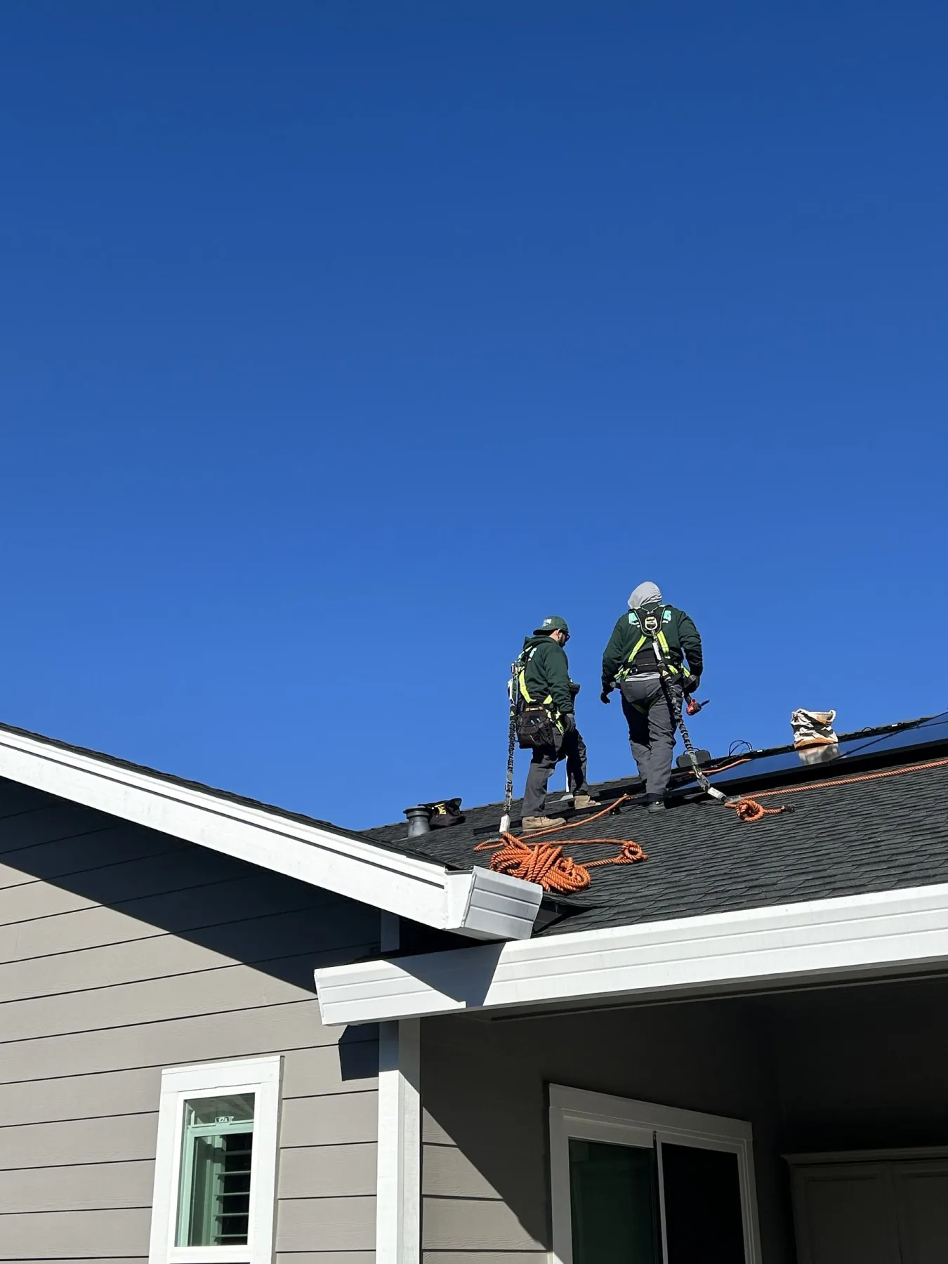 Ongaro & Sons crew installing a rooftop solar array with fall protection