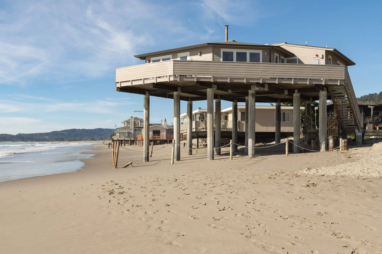 A house raised on pilings on the sand at Stinson Beach