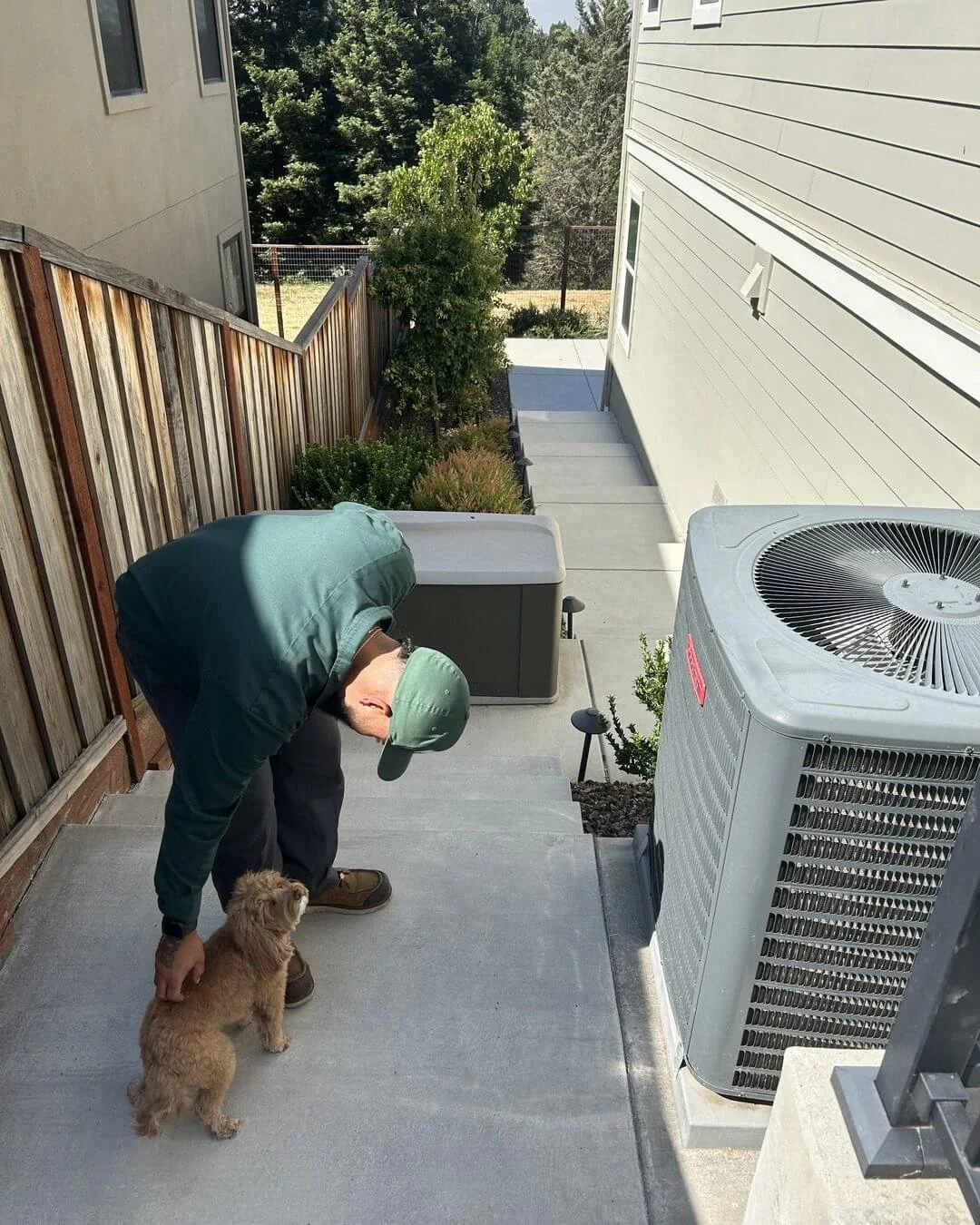 An Ongaro & Sons technician beside a residential condenser