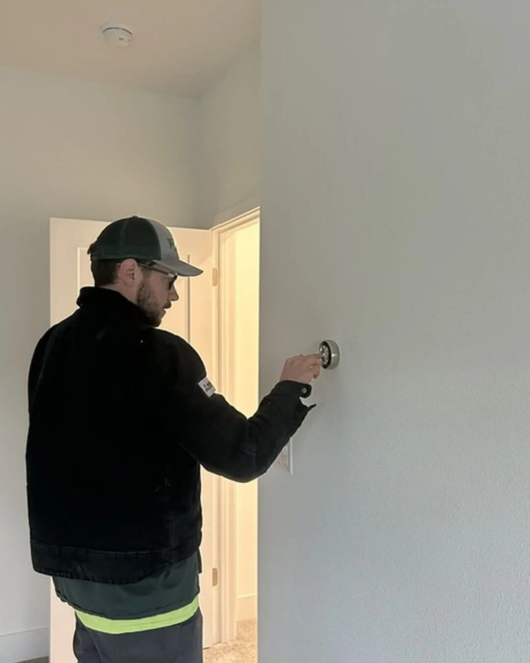 An Ongaro & Sons technician installing a smart thermostat