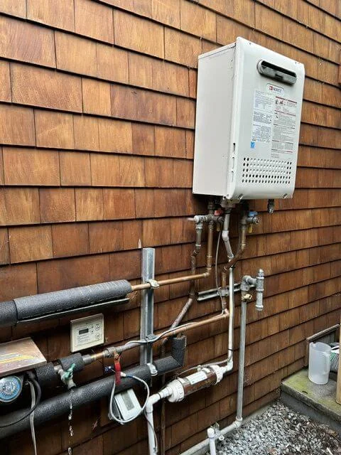 An aging tankless water heater before replacement
