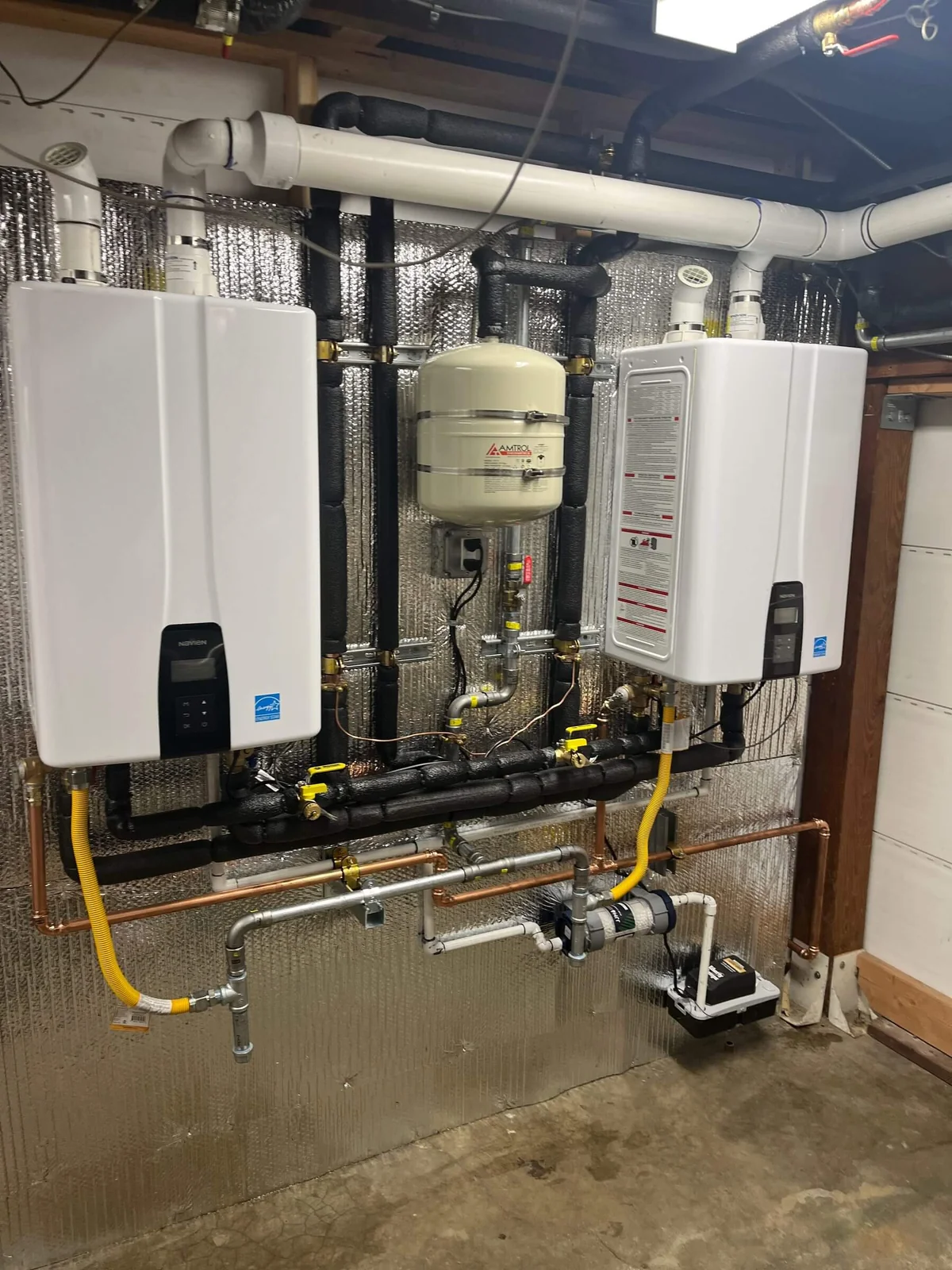Two tankless water heaters installed in a basement