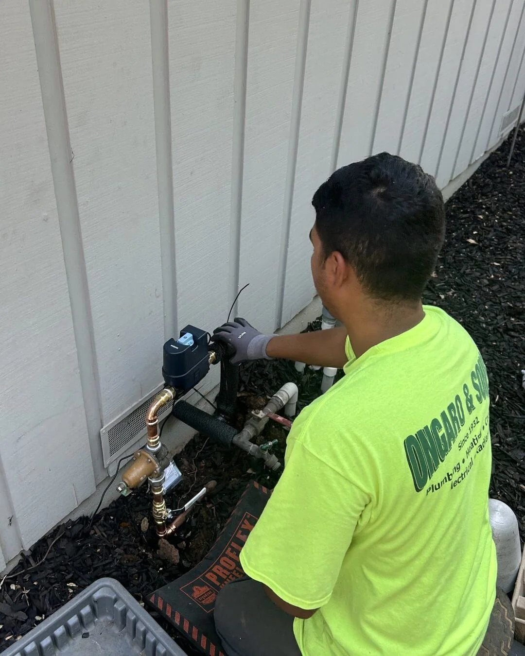 An Ongaro & Sons plumber installing a water treatment valve