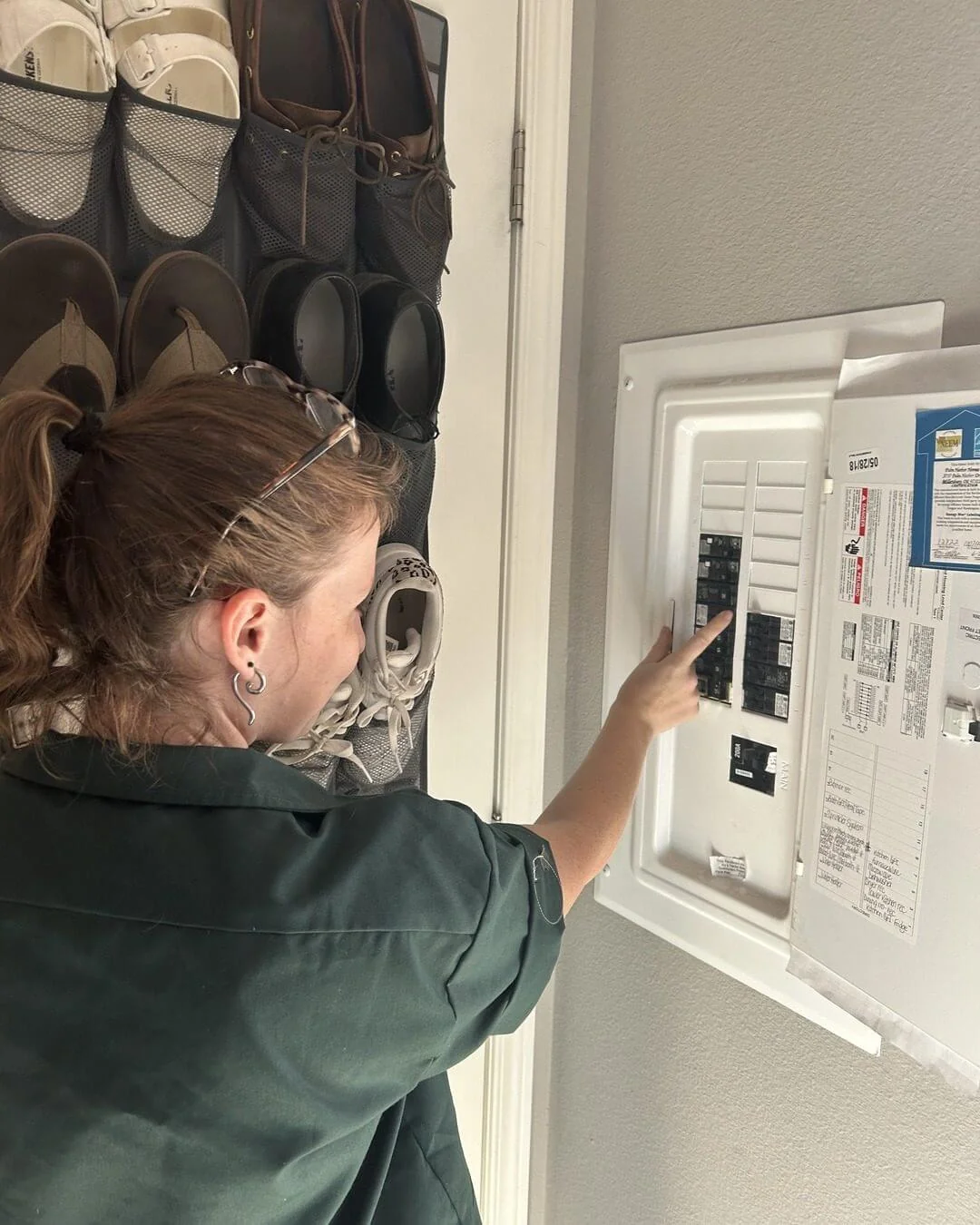 An Ongaro & Sons electrician working in a residential breaker panel