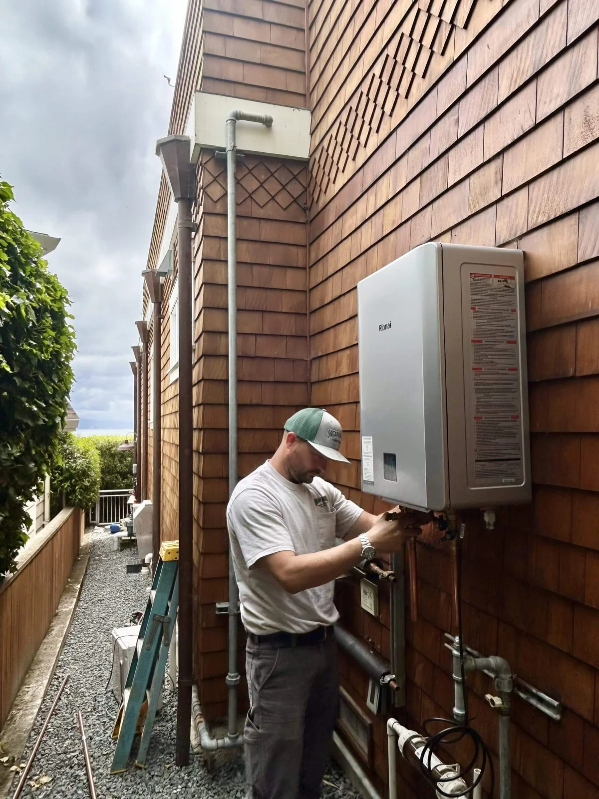 A tankless water heater installed on an exterior wall