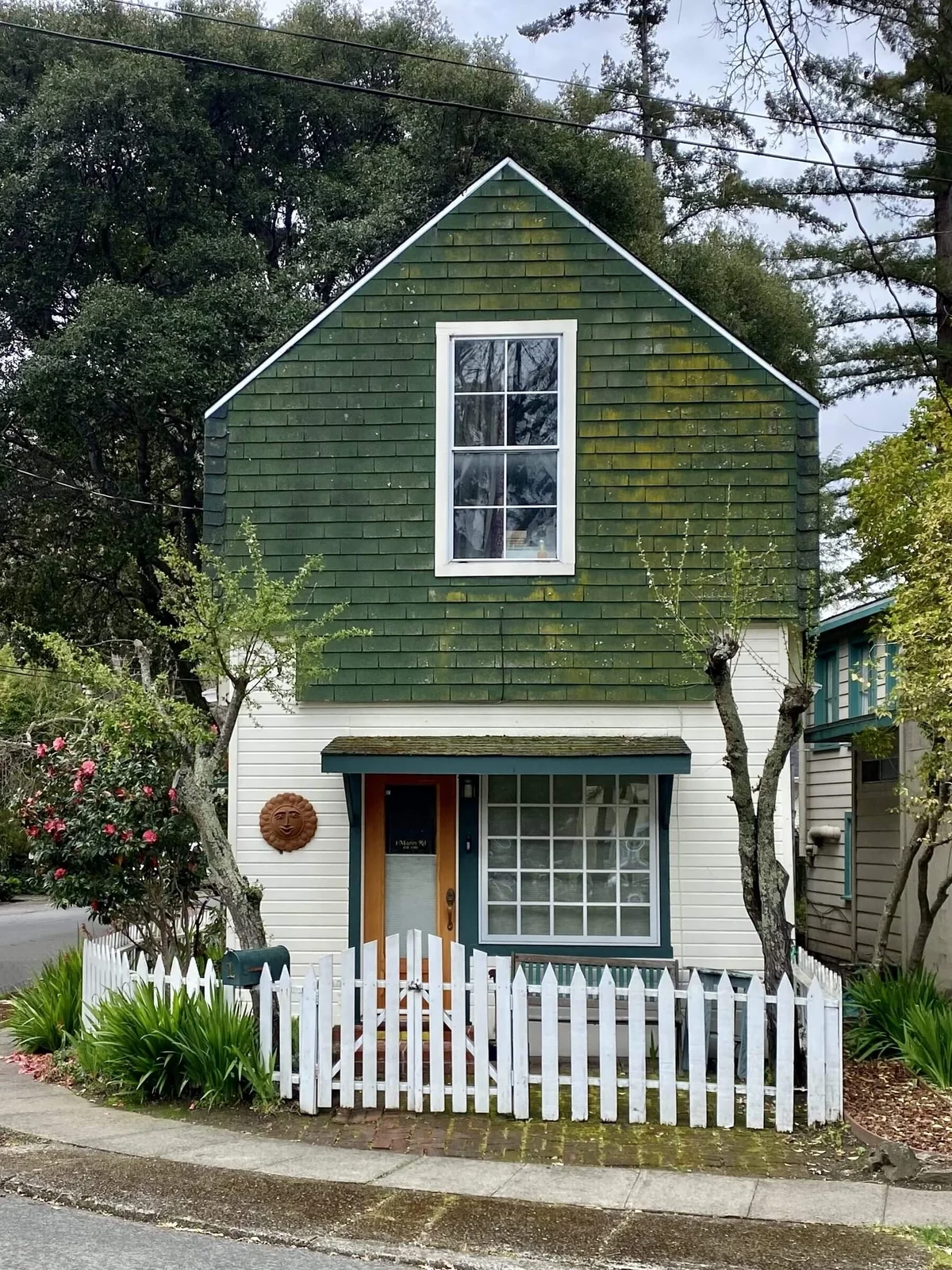 A small cottage behind a picket fence in Fairfax