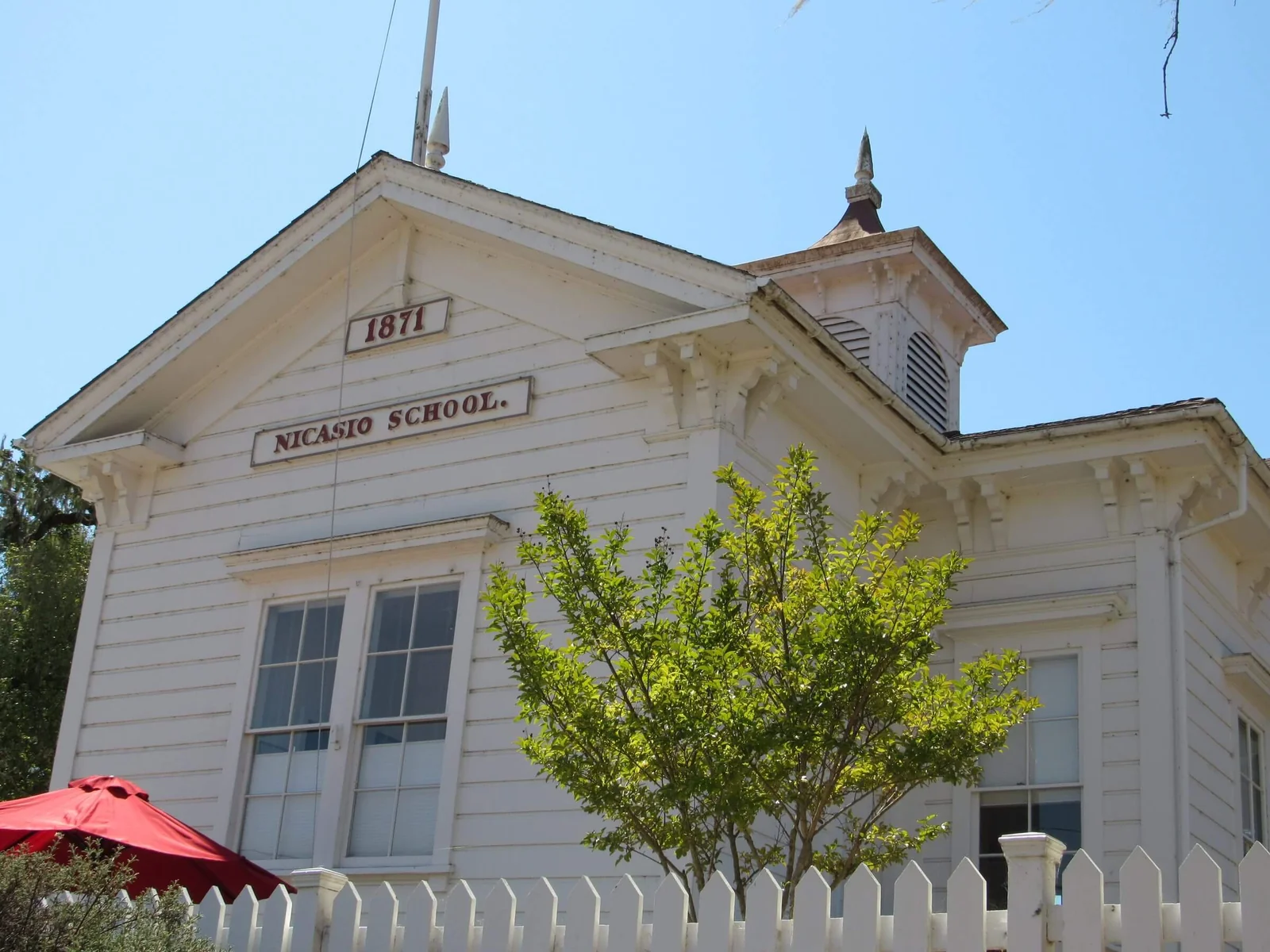 The 1871 Nicasio schoolhouse behind a picket fence