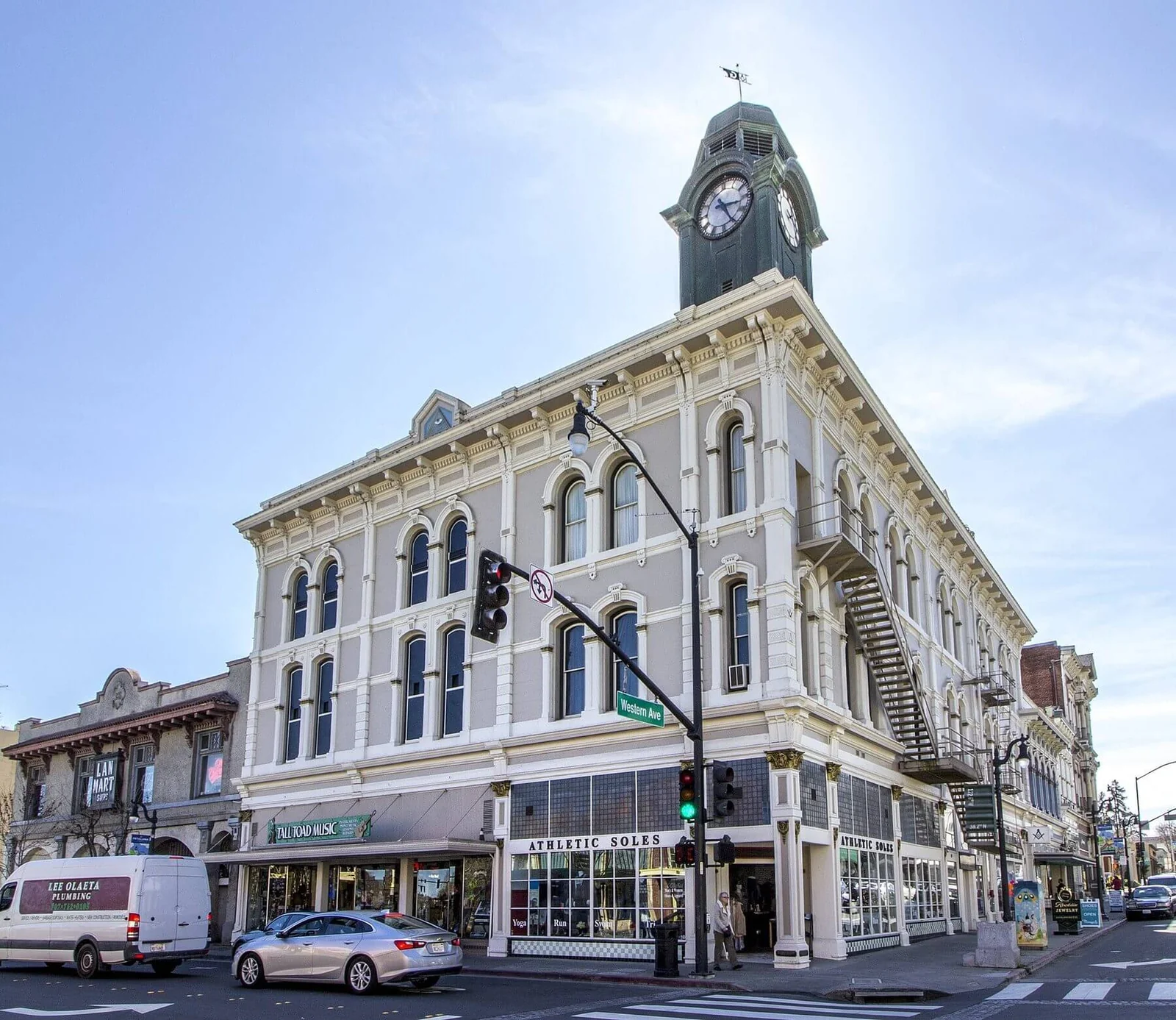 A historic clock tower building at a downtown Petaluma street corner