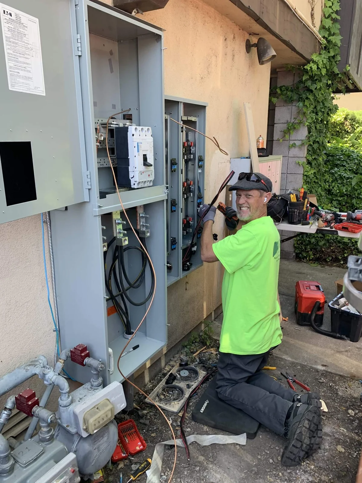 An Ongaro & Sons electrician wiring a service panel