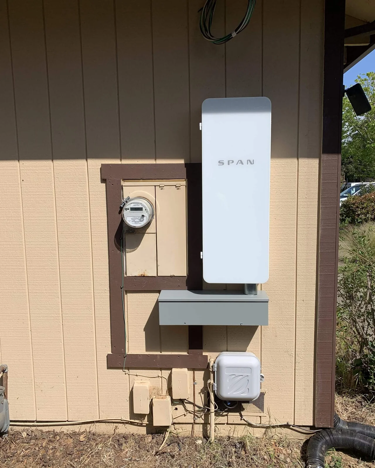 A SPAN smart electrical panel installed beside an exterior meter