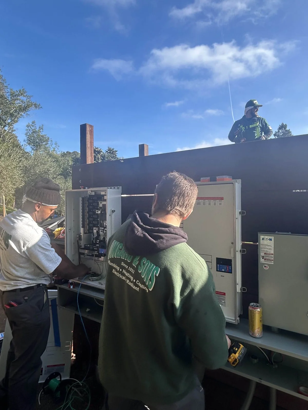 Ongaro & Sons electricians wiring an exterior panel bank