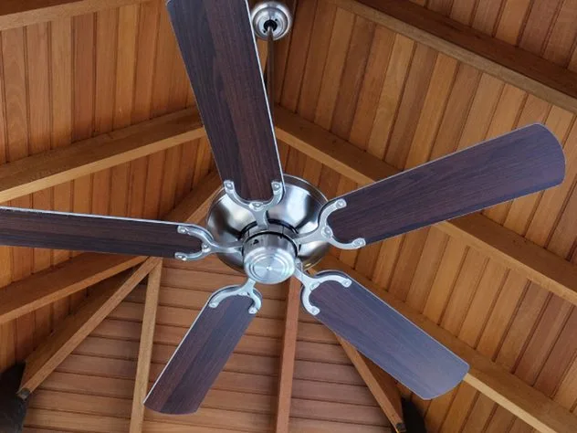Ceiling fan installed on a vaulted wood ceiling