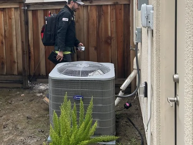 Ongaro & Sons technician diagnosing an outdoor condenser unit