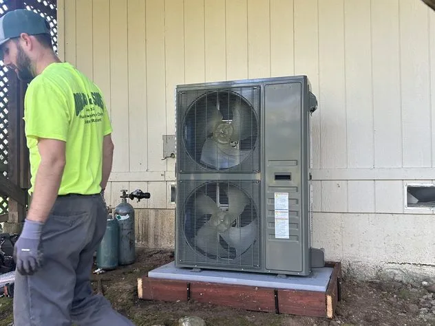 Pad-mounted heat pump outdoor unit being serviced