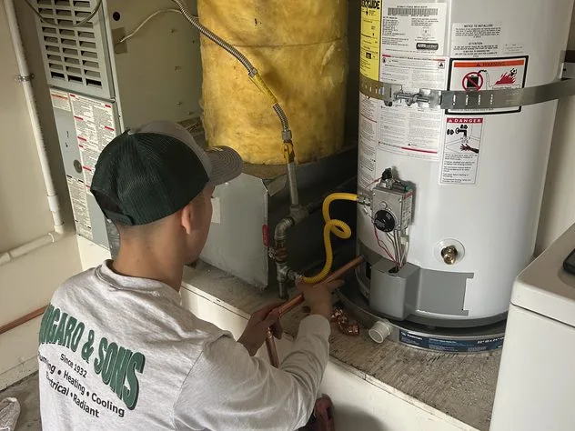 Ongaro & Sons technician working on a gas line at a water heater