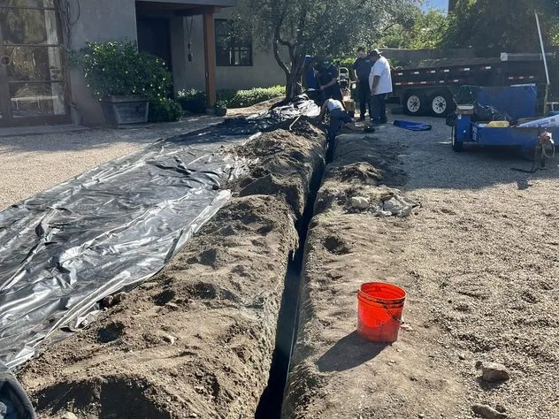 Service line trench across a driveway