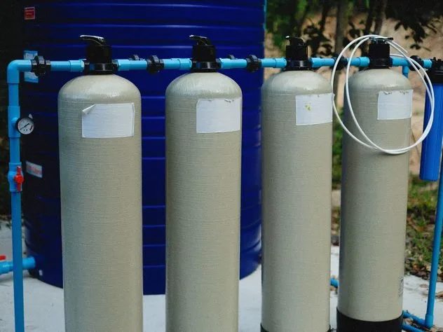 Whole-house water filtration tanks plumbed in series