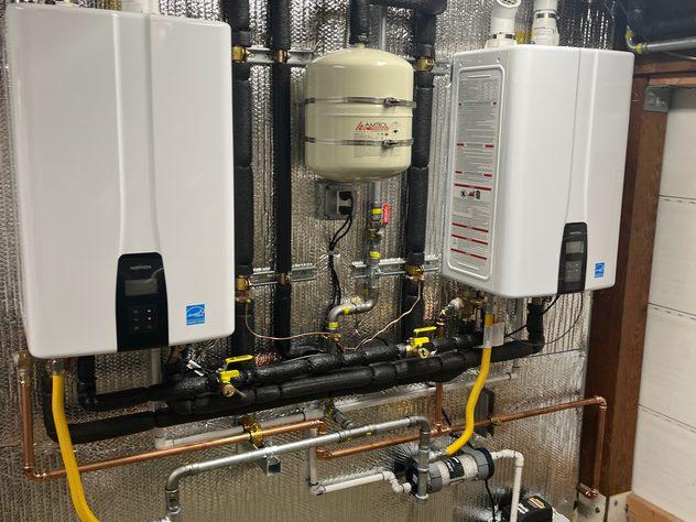 Twin Navien tankless water heaters with insulated manifold and expansion tank